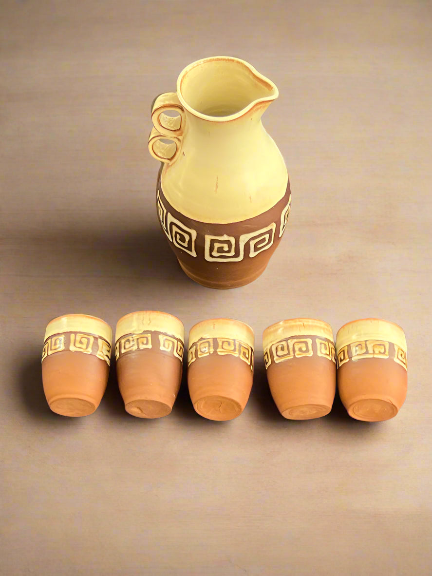 Set of ceramic pots with decorative patterns on a dark fabric background