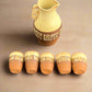 Set of ceramic pots with decorative patterns on a dark fabric background
