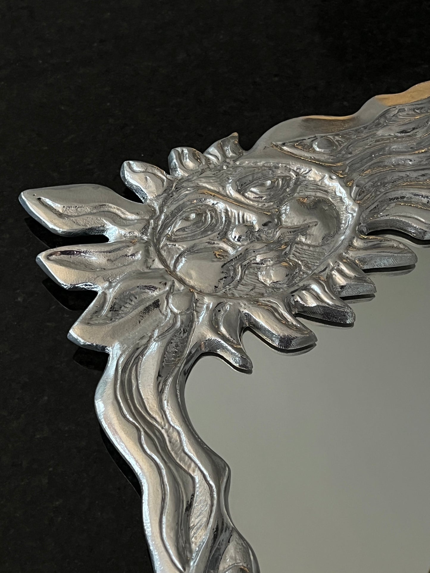 Sun face wall mirror by Donald Drumm