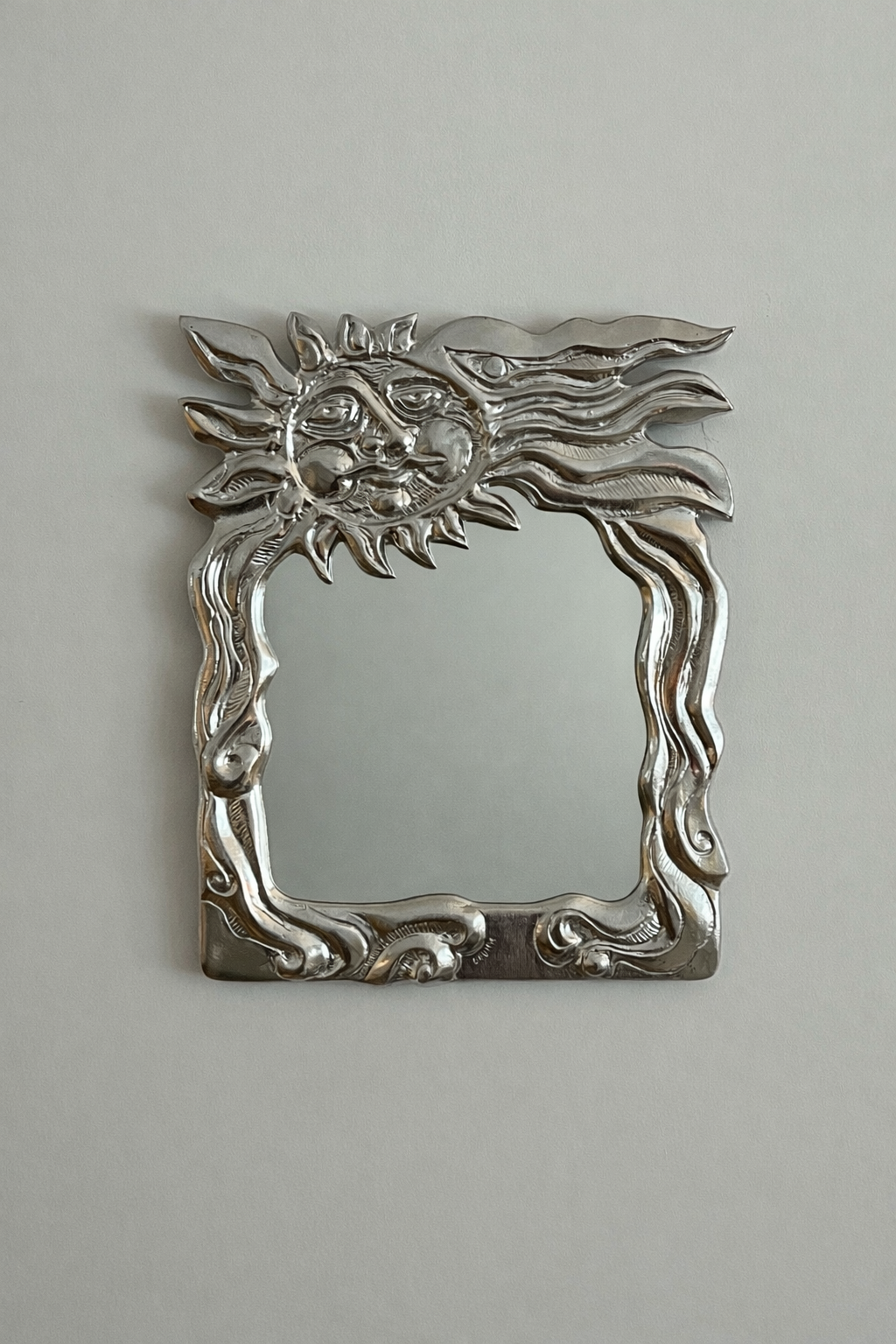 Sun face wall mirror by Donald Drumm