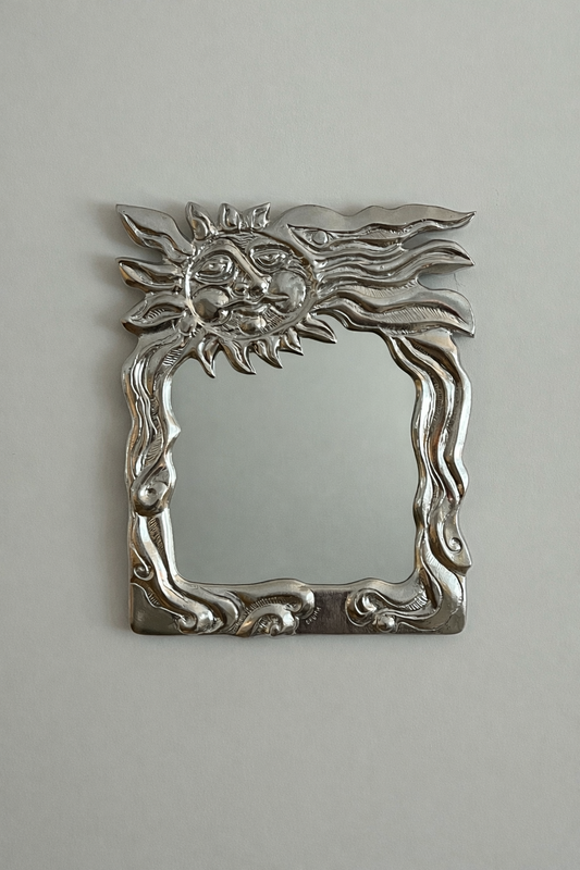 Sun face wall mirror by Donald Drumm